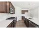 Chef's kitchen featuring stainless steel appliances, cooktop, and island with sink at 5391 Heron Bay Blvd, Locust Grove, GA 30248