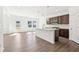 Well-lit kitchen with island, stainless appliances, and hardwood flooring at 5391 Heron Bay Blvd, Locust Grove, GA 30248
