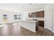 Bright kitchen with island, stainless appliances, and sliding glass doors at 5391 Heron Bay Blvd, Locust Grove, GA 30248