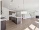 Modern kitchen with island open to living area with fireplace at 5391 Heron Bay Blvd, Locust Grove, GA 30248