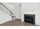 Bright living room with a fireplace and staircase, with hardwood flooring at 5391 Heron Bay Blvd, Locust Grove, GA 30248