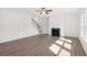 Bright living room featuring a fireplace, staircase, and light hardwood floors at 5391 Heron Bay Blvd, Locust Grove, GA 30248