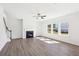 Open living room with fireplace, staircase, large windows, and wood-look flooring at 5391 Heron Bay Blvd, Locust Grove, GA 30248