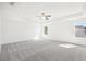 Spacious main bedroom featuring neutral carpet, white walls, recessed lighting, and ceiling fan at 5391 Heron Bay Blvd, Locust Grove, GA 30248