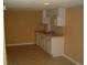 Small basement kitchen with white cabinets and tile floor at 295 Flagstone Way # 295, Austell, GA 30168