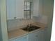 White kitchen with double sink and beige countertop at 295 Flagstone Way # 295, Austell, GA 30168