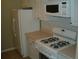 White kitchen with refrigerator and gas range at 295 Flagstone Way # 295, Austell, GA 30168