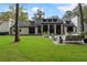 Beautiful backyard featuring a well-manicured lawn and an inviting patio with stylish outdoor furniture at 9650 Coleman Rd, Roswell, GA 30075
