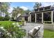 Wonderful backyard with a stone patio, stylish outdoor furniture, and manicured landscaping at 9650 Coleman Rd, Roswell, GA 30075