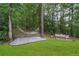 Secluded backyard oasis with a hammock, bench, and lush greenery for relaxation and enjoyment at 9650 Coleman Rd, Roswell, GA 30075