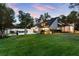 A spacious lawn and contemporary home featuring a patio with outdoor furnishings and manicured landscaping at 9650 Coleman Rd, Roswell, GA 30075