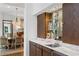 Chic bar area with marble countertop, wooden cabinetry, and glass shelves at 9650 Coleman Rd, Roswell, GA 30075