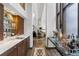 Home bar featuring custom cabinetry, marble countertops, wine storage, and glass shelving at 9650 Coleman Rd, Roswell, GA 30075