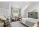Bedroom with light blue walls, sloped ceilings, decorative furniture, and chandelier at 9650 Coleman Rd, Roswell, GA 30075