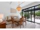 Dining room featuring a modern chandelier, comfortable seating, and view to the backyard at 9650 Coleman Rd, Roswell, GA 30075