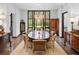 Bright dining room featuring elegant furnishings, large windows with beautiful views, and hardwood floors at 9650 Coleman Rd, Roswell, GA 30075