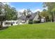 Lovely exterior view showcasing the expansive lawn and carefully curated landscaping, enhancing curb appeal at 9650 Coleman Rd, Roswell, GA 30075