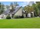 Charming exterior with a spacious lawn and tastefully landscaped grounds, creating a welcoming ambiance at 9650 Coleman Rd, Roswell, GA 30075