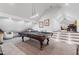 Bright game room with a pool table, seating area, and steps leading to another entertainment space at 9650 Coleman Rd, Roswell, GA 30075