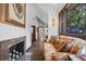 Hallway with floral sofa, fireplace, wall art, and dark trim at 9650 Coleman Rd, Roswell, GA 30075