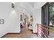 Bright hallway with hardwood floors, white walls, accent lighting, and red railing at 9650 Coleman Rd, Roswell, GA 30075