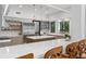 Bright kitchen featuring stainless appliances, modern lighting, breakfast bar, and views to the backyard at 9650 Coleman Rd, Roswell, GA 30075