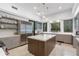 Well-lit kitchen boasts a center island with a wood accent, stainless steel appliances, and custom cabinetry at 9650 Coleman Rd, Roswell, GA 30075