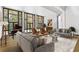 Bright living room featuring large windows, comfortable seating, and a grand piano at 9650 Coleman Rd, Roswell, GA 30075