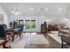 Open-concept living and dining space with wood floors, patio doors, and elegant furnishings at 9650 Coleman Rd, Roswell, GA 30075