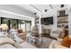 Comfortable living room features fireplace, custom lighting and backyard view at 9650 Coleman Rd, Roswell, GA 30075