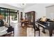 Living room featuring elegant decor, a piano, and views to the outdoor living area at 9650 Coleman Rd, Roswell, GA 30075