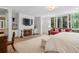 Bright main bedroom featuring a fireplace, built-in shelving, a cozy seating area, and large windows at 9650 Coleman Rd, Roswell, GA 30075