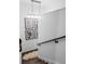 Modern staircase with dark wood steps and a minimalist railing with artwork at 9650 Coleman Rd, Roswell, GA 30075