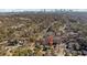 Aerial view of a neighborhood with trees and a city skyline in the distance at 67 Holly Nw Rd, Atlanta, GA 30314