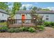 Relaxing backyard featuring a wood deck with chairs, string lights, and attractive gravel at 67 Holly Nw Rd, Atlanta, GA 30314