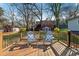Inviting backyard wooden deck features comfortable seating with blue pillows and a backyard view at 67 Holly Nw Rd, Atlanta, GA 30314