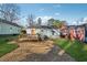 Backyard featuring a wooden deck, gravel area, green lawn, and an orange door at 67 Holly Nw Rd, Atlanta, GA 30314