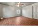 This is an empty bedroom with wood floors, a ceiling fan, and ample space at 67 Holly Nw Rd, Atlanta, GA 30314