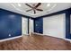 A blue-walled bedroom has an ensuite bathroom and a closet with folding doors at 67 Holly Nw Rd, Atlanta, GA 30314