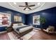 Bedroom featuring a blue accent wall, a ceiling fan, and a neutral-colored rug at 67 Holly Nw Rd, Atlanta, GA 30314