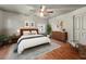 Bedroom with wooden floors, ceiling fan, a large area rug, and tastefully chosen decorations at 67 Holly Nw Rd, Atlanta, GA 30314