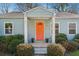 Close-up of the home's welcoming orange front door and well-manicured front yard landscaping at 67 Holly Nw Rd, Atlanta, GA 30314