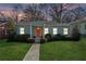 Charming single-story home featuring a well-manicured lawn and a bright orange front door at 67 Holly Nw Rd, Atlanta, GA 30314