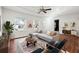 Bright living room featuring hardwood floors, a modern sectional sofa, and a ceiling fan at 67 Holly Nw Rd, Atlanta, GA 30314