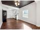 Bright and airy living room open to a modern kitchen with white cabinets and stainless steel appliances at 67 Holly Nw Rd, Atlanta, GA 30314