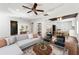Bright living room featuring hardwood floors, a modern sectional sofa, and a ceiling fan at 67 Holly Nw Rd, Atlanta, GA 30314