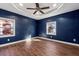 Spacious main bedroom with tray ceilings, ceiling fan, and two bright windows at 67 Holly Nw Rd, Atlanta, GA 30314