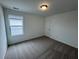 Bright bedroom with neutral carpet and window at 2120 Boxwood Se Cir, Conyers, GA 30094