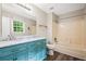 Bathroom features a blue double sink vanity with marble countertop and shower-tub combo at 2382 Old Rex Morrow Rd, Ellenwood, GA 30294