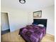 Bedroom with a queen-size bed and purple comforter at 2382 Old Rex Morrow Rd, Ellenwood, GA 30294